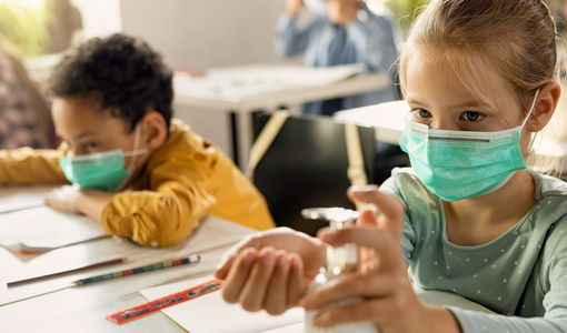 Schüler mit Maske beim Lernen in der Klasse