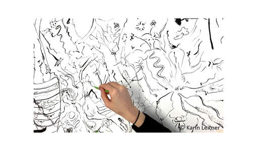 Hand zeichnet mit grünem Stift auf großem schwarz-weißem Linienbild.